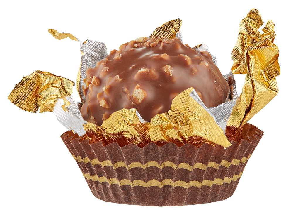 Beautiful candy in gold wrapper ball shape in paper skirt isolated on white with shadows. Full sharpness across the surface.