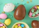 Easter sweets concept. Top view photo of easter bunny ears chocolate eggs with dragees and sprinkles on turquoise background with empty space