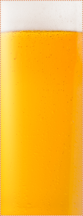 Cold glass of lager beer with foam and dew isolated on white background