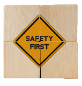 Safety symbols and first signs, work safety, caution work hazards, danger surveillance, zero accident concept on wooden cubes with beautiful grey background and copy space. Safety banner. 