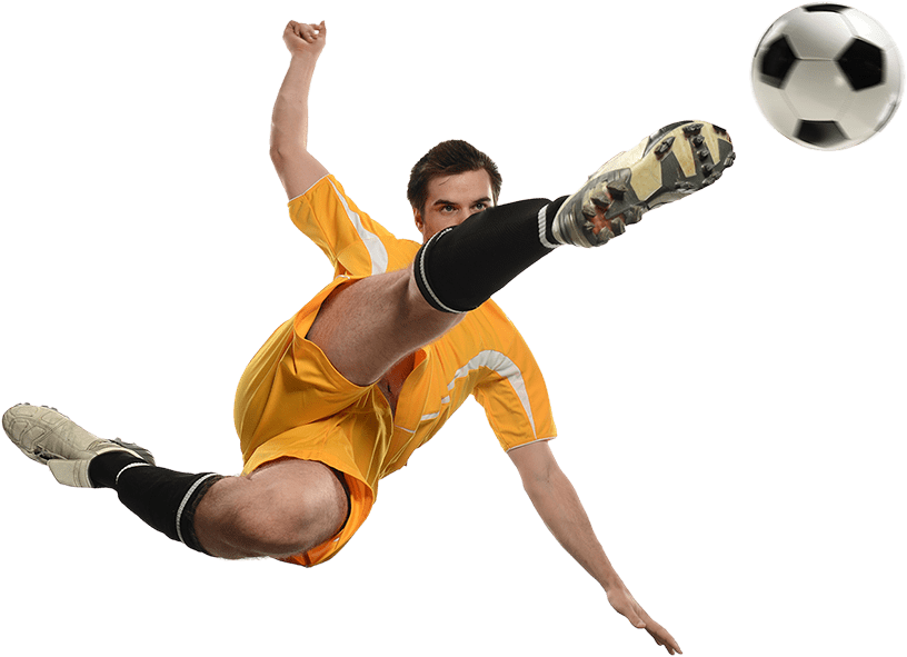 Soccer player kicking ball while jumping isolated over white background