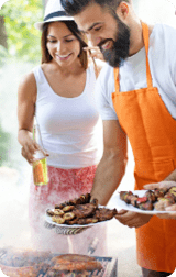 Friends having a barbecue party in nature while having a blast