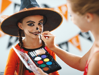 happy family mother and daughter getting ready for halloween make make-up