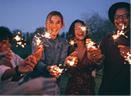 Group of friends enjoying out with sparklers  Young men and women enjoying with fireworks 