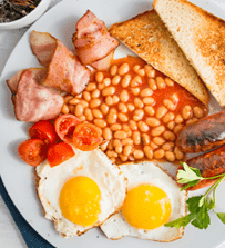 Full english breakfast served on white wooden table. Closeup. Top view.