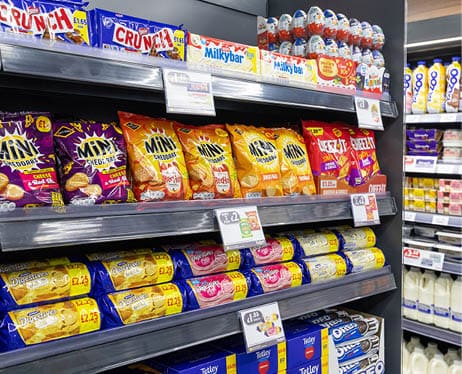 A store shelf with snacks and drinks. Description generated by AI
