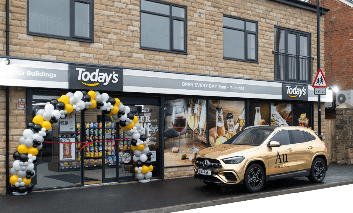 A gold car is parked in front of a building. Description generated by AI