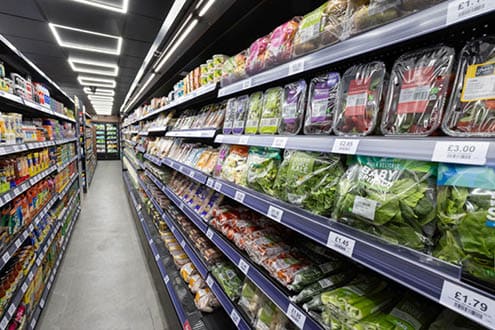 A grocery store with a blue and white sign. Description generated by AI