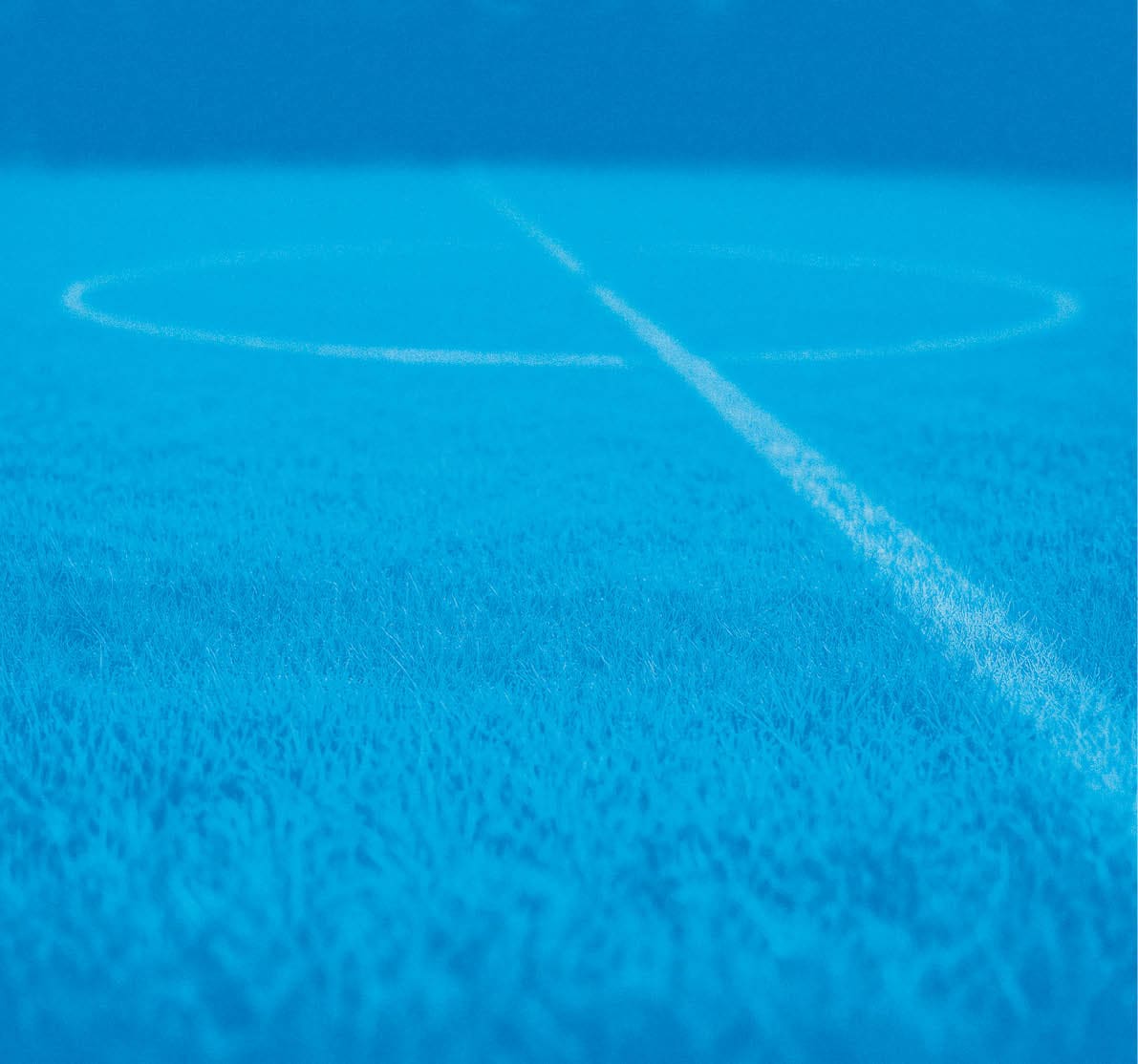 A blue soccer field with a white line. Description generated by AI
