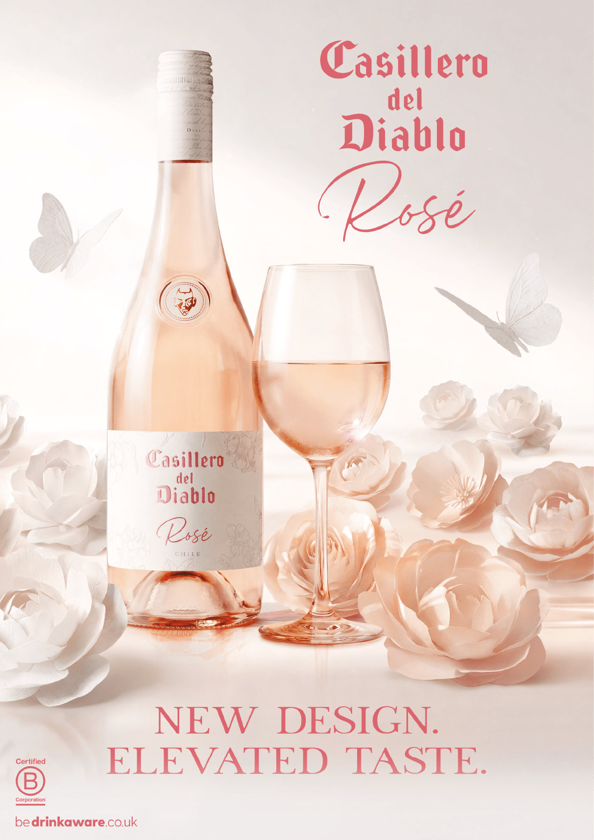 A bottle of wine and a wine glass with pink roses. Description generated by AI