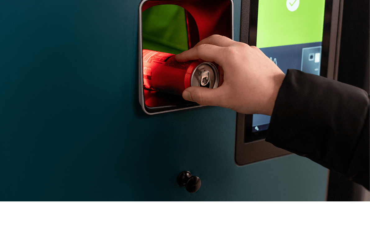 A person is using a machine that has a red screen. Description generated by AI