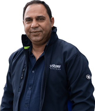 A man wearing a blue shirt and black jacket. Description generated by AI