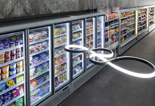 A refrigerator with a light on inside. Description generated by AI