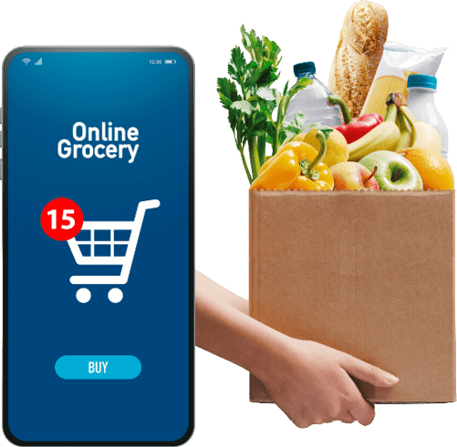 A hand holds a grocery bag filled with fresh produce and groceries next to a smartphone screen displaying an online grocery shopping app with a shopping cart icon and a notification. Description generated by AI