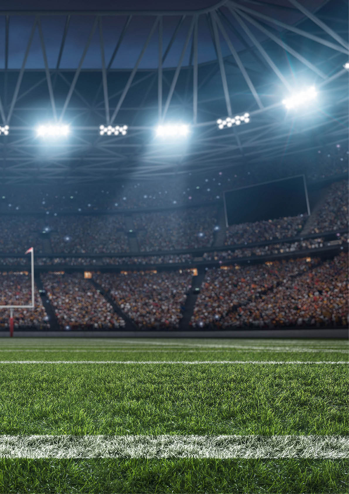 A brightly lit football stadium filled with a large crowd and a clear view of the goalposts on the field. Description generated by AI
