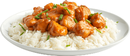 Chunks of chicken coated in a glossy orange sauce served over white rice garnished with chopped green herbs on a white plate. Description generated by AI