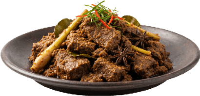 Spiced beef rendang garnished with lemongrass, star anise, and sliced chili peppers on a dark plate. Description generated by AI