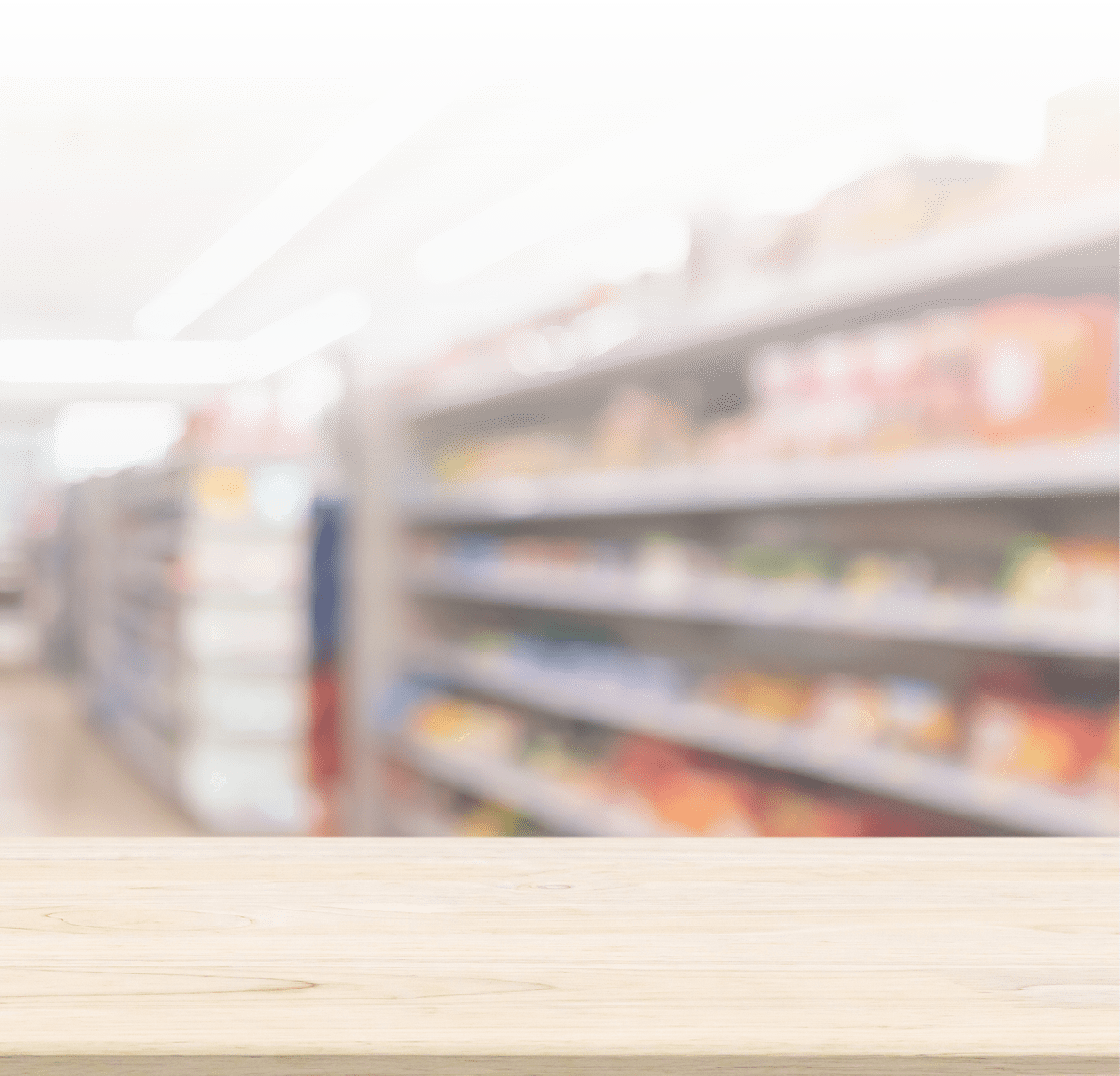 A wooden tabletop is in sharp focus with blurred shelves of various products in the background, suggesting a store or supermarket setting. Description generated by AI