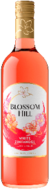 A bottle of Blossom Hill White Zinfandel wine with a floral design on the label and a gold cap. Description generated by AI
